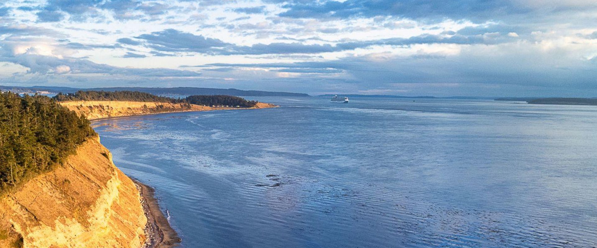 Coastal view of Whidbey Island shoreline and water, representing different places to live and lifestyle options across the island